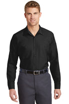 Male model wearing Red Kap Men's Long Sleeve Industrial Work Shirt in black, featuring button-front closure and dual chest pockets