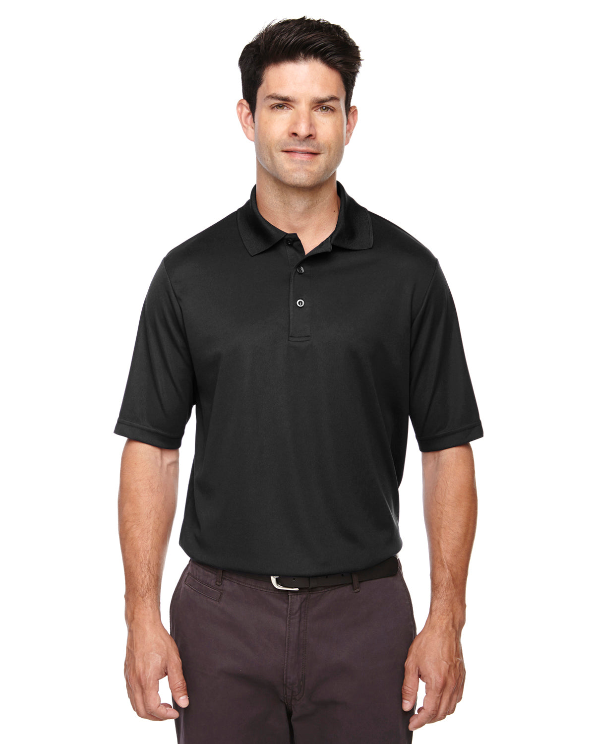 Tall male model wearing Core365 Origin Performance Piqué Polo in black, designed with moisture-wicking fabric and athletic fit.