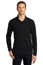 Model in Port Authority Dry Zone Long Sleeve Polo in deep black, featuring breathable mesh fabric, moisture-wicking performance, and a relaxed fit with polo collar.