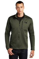 Male model wearing The North Face Skyline Full-Zip Fleece Jacket in forged iron heather, featuring a streamlined fit, full front zipper, and embroidered chest logo.