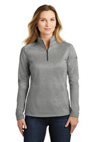 Female model wearing The North Face Ladies 1/4-Zip Fleece in asphalt grey heather, highlighting lightweight warmth and zippered collar.